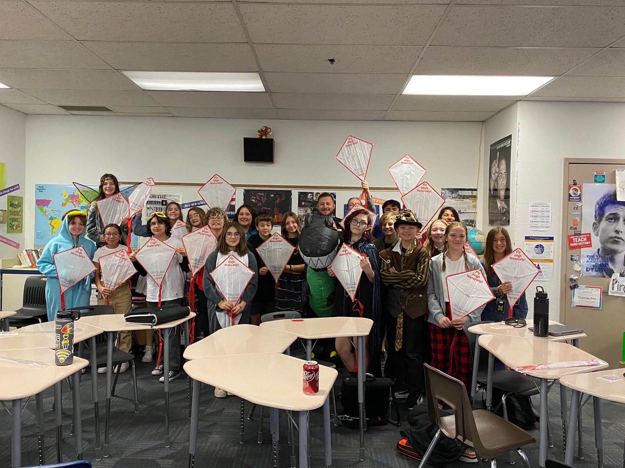 Classroom of students holding up handmade kites.